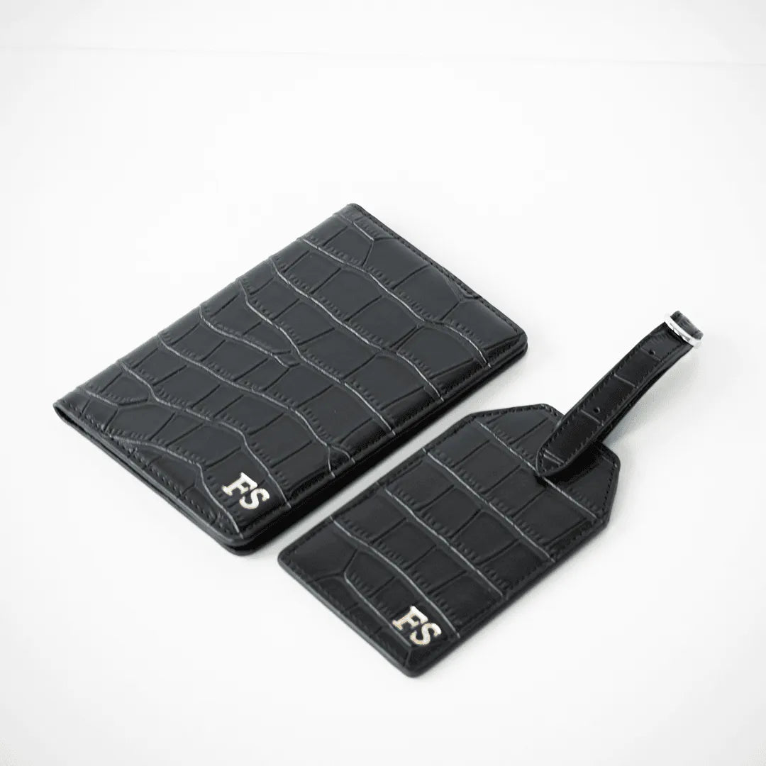 Black personalised leather passport holder and luggage tag customisable with your name perfect for travel and gifting