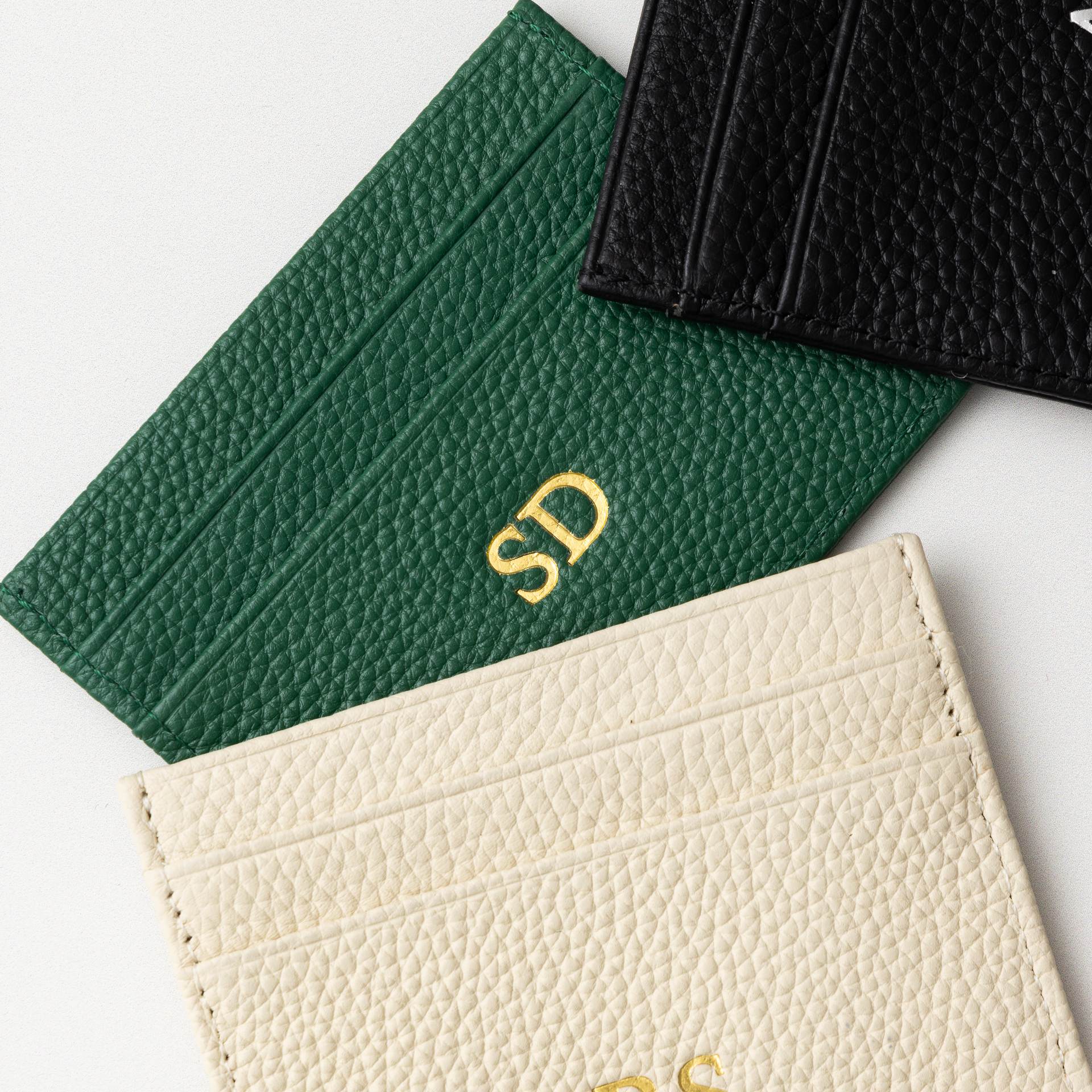 A collection of genuine leather card holders, each featuring a smooth and durable texture, highlighting their high-quality craftsmanship and stylish design.